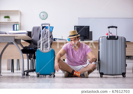 Young male employee preparing for the trip Young male employee preparing for the trip 67612703