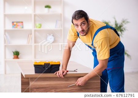 Young male carpenter working indoors 67612791