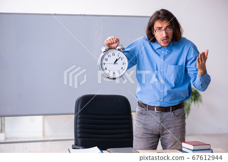 Young male teacher in the classroom Young male teacher in the classroom 67612944