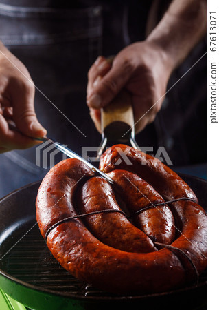 Homemade sausage cooked on a grill, with tomatoes. Homemade sausage cooked on a grill, with tomatoes. 67613071