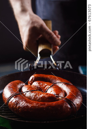 Homemade sausage cooked on a grill, with tomatoes. Homemade sausage cooked on a grill, with tomatoes. 67613073