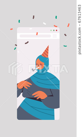 arabic woman in festive hat celebrating online birthday party celebration self isolation quarantine 67613463
