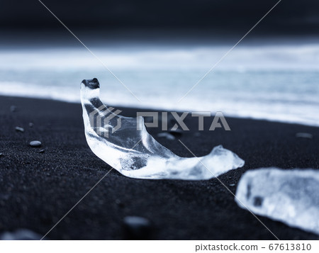 Diamond beach, Iceland. Ice on black sand on the beach. Ocean bay and icebergs. Diamond beach, Iceland. Ice on black sand on the beach. Ocean bay and icebergs. 67613810