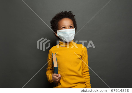 Happy black child boy in medical protective face 67614858