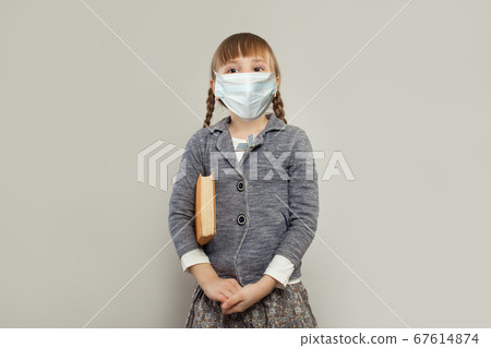 Happy smart child girl wearing medical protective mask 67614874