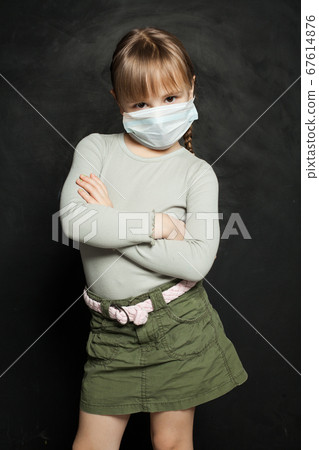 Small child girl in medical protective face mask 67614876
