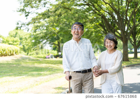 Senior couple walking in the park and rehabilitating 67615868