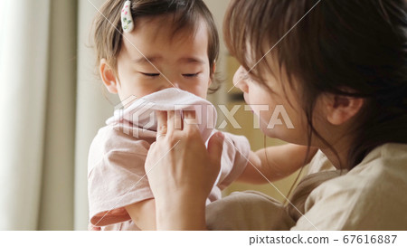 Baby and mom wiping drool Baby and mom wiping drool 67616887