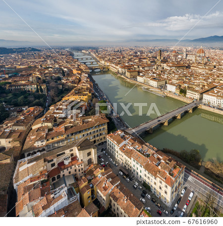 Aerial panorama of Florence at sunrise, Firenze, Tuscany, Italy, cathedral, river, drone pint view, mountains is on background Aerial panorama of Florence at sunrise, Firenze, Tuscany, Italy, cathedral, river, drone pint view, mountains is on background 67616960