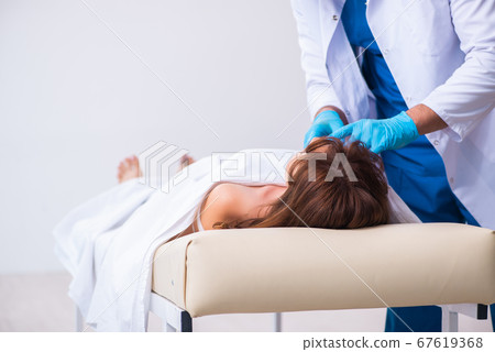 Police coroner examining dead body corpse in morgue Police coroner examining dead body corpse in morgue 67619368