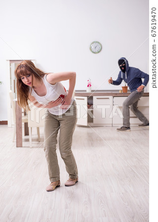 Gangster and young woman in robbery concept 67619470