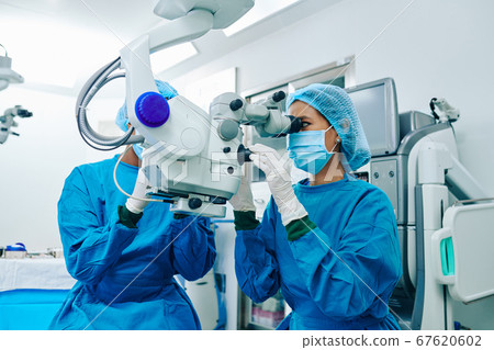 Surgeon operating patient 67620602