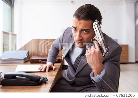 Young male employee unhappy with excessive work Young male employee unhappy with excessive work 67621200