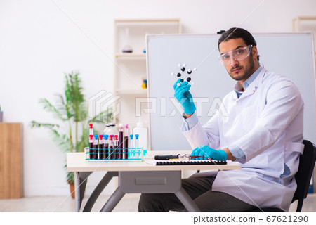 Young male chemist working in the lab Young male chemist working in the lab 67621290