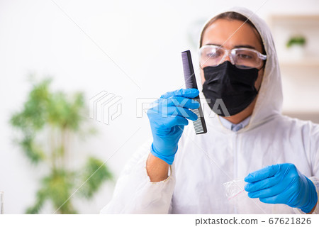 Male expert criminologist working in the lab for evidence Male expert criminologist working in the lab for evidence 67621826