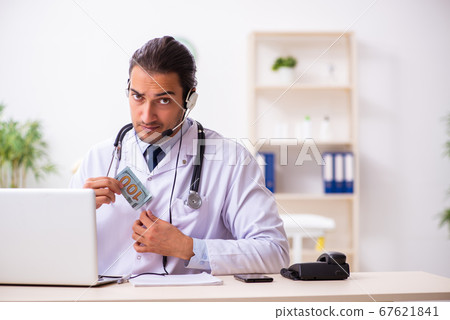 Young doctor listening to patient during telemedicine session 67621841
