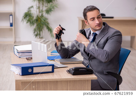 Young male employee in the office during pandemic disease Young male employee in the office during pandemic disease 67621959