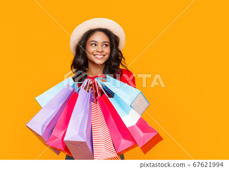 Stylish ethnic woman with shopping bags. 67621994