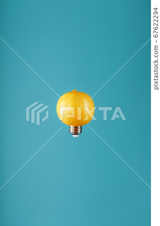 Lemon as a light bulb in levitation on a blue 67622294