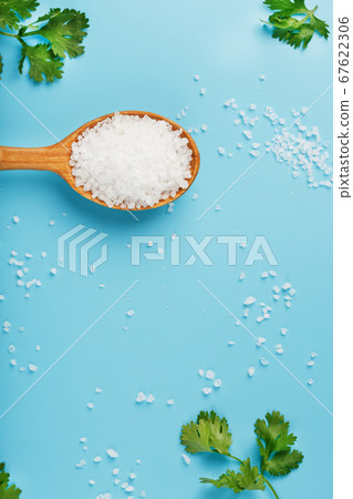 Sea salt in a wooden spoon on Large salt crystals Sea salt in a wooden spoon on Large salt crystals 67622306
