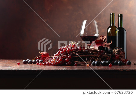 Red wine and fresh grapes with dried up vine Red wine and fresh grapes with dried up vine 67623720