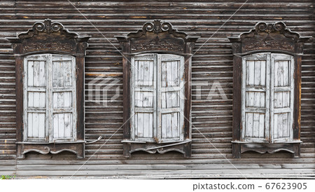 Shuttered windows of an old wooden residential Shuttered windows of an old wooden residential 67623905