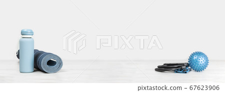 Rolled yoga mat and exercise resistance band and water bottle 67623906