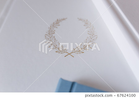 Photobook with different lettering on white wooden table 67624100