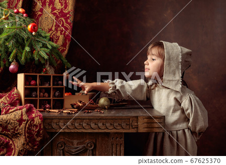 Little girl in an vintage linen dress near the 67625370