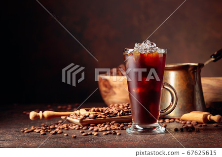 Ice coffee in frozen glass and coffee beans on a Ice coffee in frozen glass and coffee beans on a 67625615
