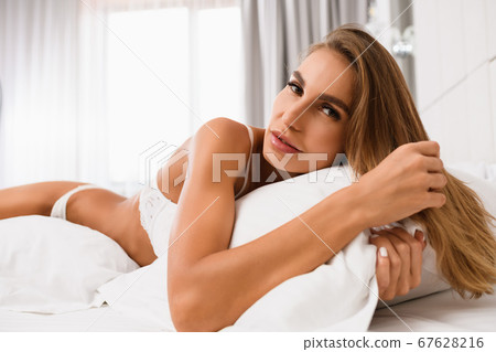 Sexy woman in white underwear in bed Sexy woman in white underwear in bed 67628216
