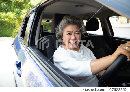 Asian senior woman driving a car and smile happy Asian senior woman driving a car and smile happy 67628262
