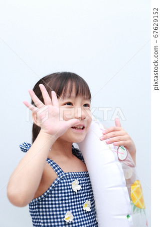 Girl playing in a float wearing a swimsuit in midsummer Girl playing in a float wearing a swimsuit in midsummer 67629152