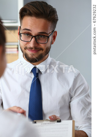 Cheerful handsome bearded man offering contract to partner 67629232