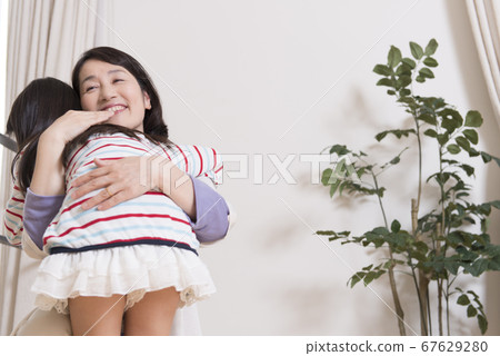 Grandmother playing with grandchild 67629280