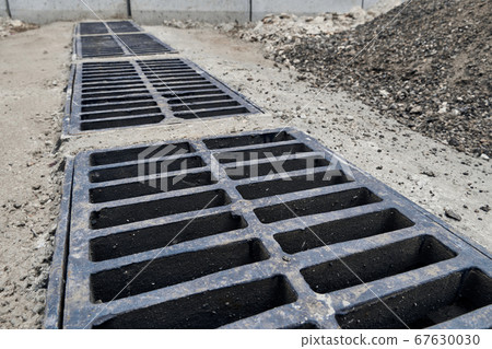 New rainwater grate on the road or sidewalk, 67630030