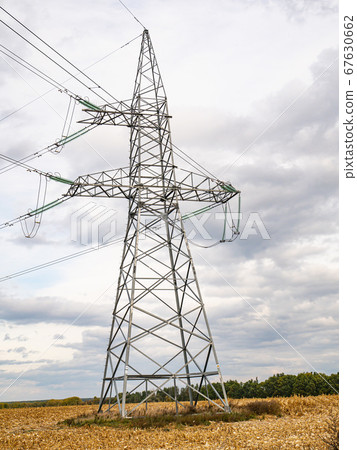 Towers of high-voltage energy transfer against a cloudy sky. Towers of high-voltage energy transfer against a cloudy sky. 67630662
