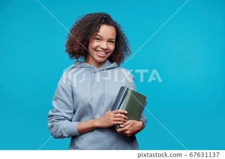 Smiling student girl in hoodie 67631137