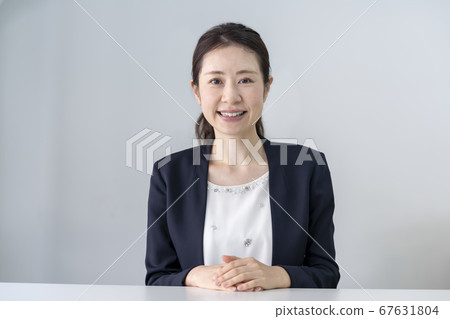 Portrait of a smiling woman in her thirties Portrait of a smiling woman in her thirties 67631804