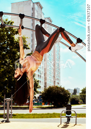 Strong and sexy sportive woman training outdoors, on the ground Strong and sexy sportive woman training outdoors, on the ground 67637107
