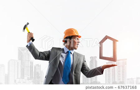 Businessman going to crash with hammer house 67637168