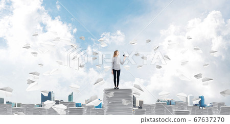Woman keeping megaphone in hand. Woman keeping megaphone in hand. 67637270