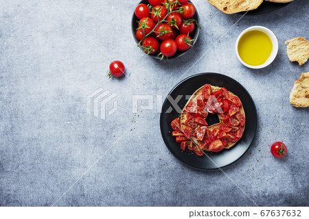 Friselle with tomato, oil and origano Friselle with tomato, oil and origano 67637632