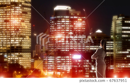 Woman looking at night city Woman looking at night city 67637951