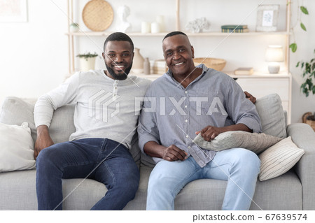 Portrait With Dad. Happy Black Man Posing With Mature Father At Home Portrait With Dad. Happy Black Man Posing With Mature Father At Home 67639574