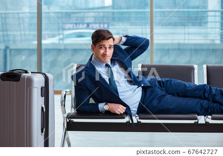 Businessman waiting at the airport for his plane in business cla 67642727