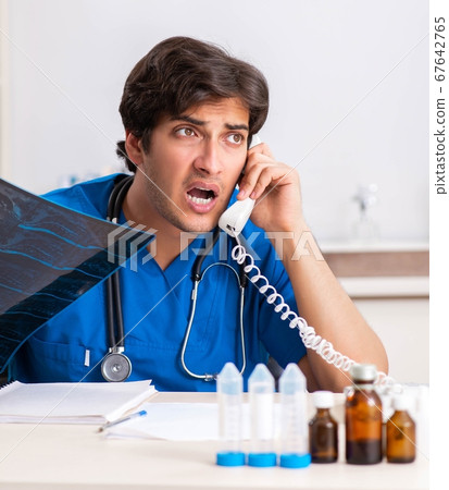 Doctor in telemedicine concept with phone Doctor in telemedicine concept with phone 67642765