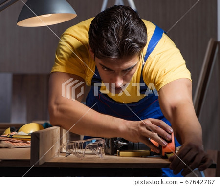 Worker working in repair workshop in woodworking concept Worker working in repair workshop in woodworking concept 67642787