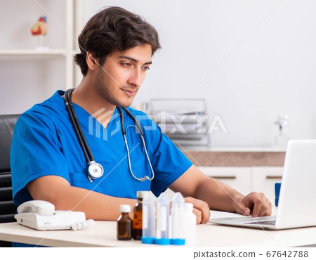 Young doctor working in the hospital Young doctor working in the hospital 67642788