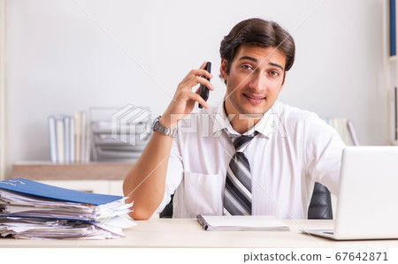 Young handsome businessman working in office Young handsome businessman working in office 67642871
